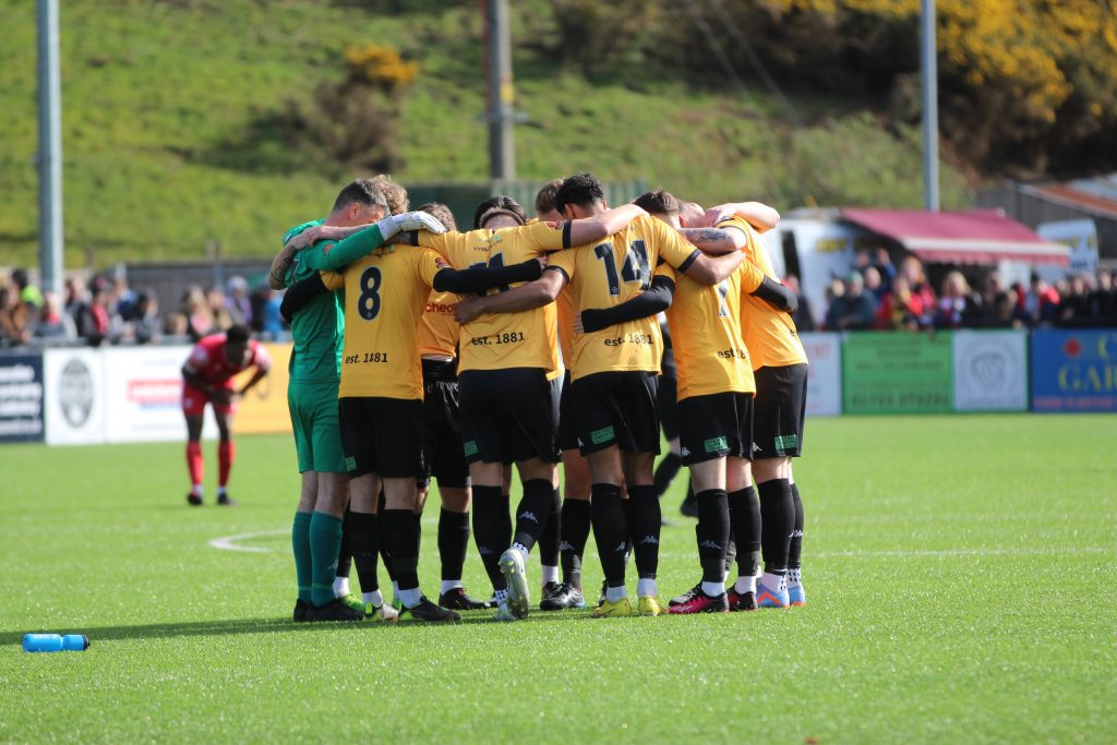 Southport players huddle before Scarborough